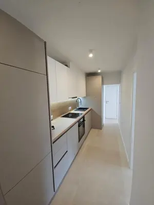 a kitchen with white cabinets and a sink and a stove at Apartment DANICA in Banja Luka