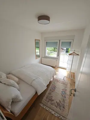 a bedroom with a large bed and a window at Apartment DANICA in Banja Luka