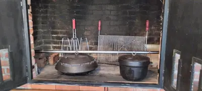 a kitchen with pots and pans in a brick wall at Vikendica Harun in Bihać
