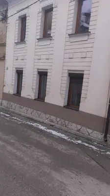 a white building with windows on the side of it at Luni in Travnik