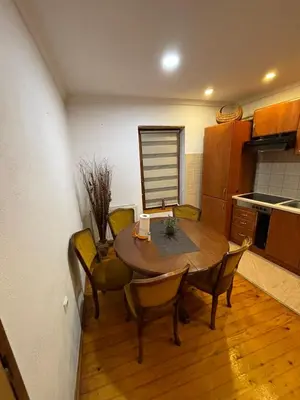 a kitchen with a table and chairs in a room at Luni in Travnik