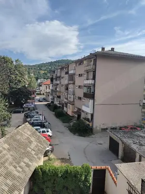 an overhead view of a parking lot with a building at Luni in Travnik