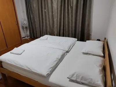 a bed with two white sheets and two pillows at Luni in Travnik
