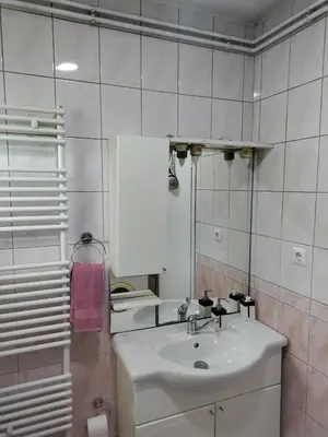a white bathroom with a sink and a toilet at Luni in Travnik
