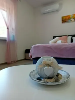 a plate on a table with a bowl of rocks at Apartman Edwin Jajce in Jajce