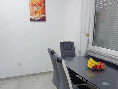 a dining room table with a bowl of fruit on it at Apartman Edwin Jajce in Jajce