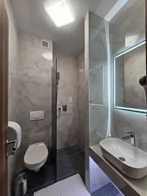 a bathroom with a toilet and a sink and a shower at Hostel PREMIUM in Derventa