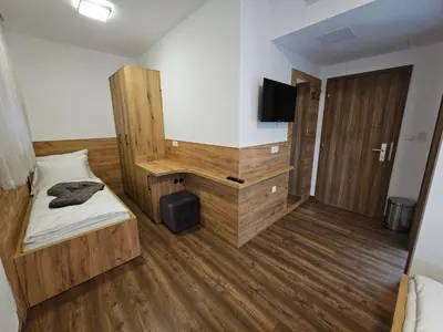 a room with a bed and a television in it at Hostel PREMIUM in Derventa