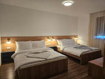 a hotel room with two beds in a room at Hostel PREMIUM in Derventa