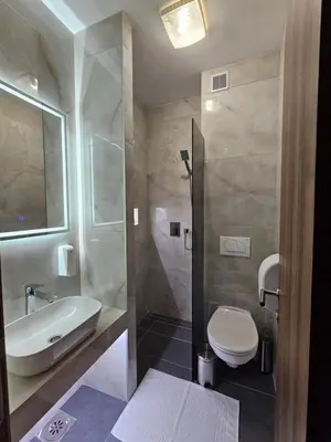 a bathroom with a sink and a toilet and a shower at Hostel PREMIUM in Derventa