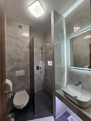 a bathroom with a sink and a toilet and a shower at Hostel PREMIUM in Derventa