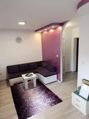 a living room with a couch and a table at Apartman Central in Doboj