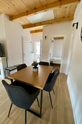 a dining room with a wooden table and chairs at Antiva in Livno