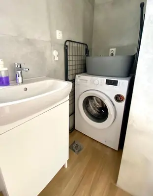 a bathroom with a washing machine and a sink at Antiva in Livno