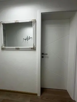 a door in a room with a mirror on the wall at Apartmаn Avram ll in Kotor-Varoš