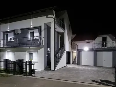 a white building with two balconies and a staircase at Apartmаn Avram ll in Kotor-Varoš
