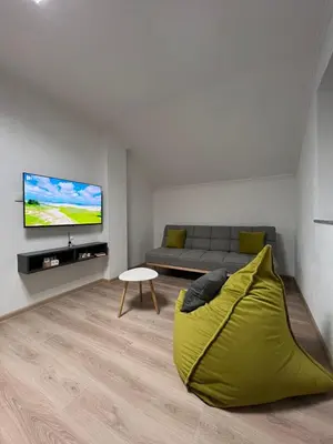 a living room with a couch and a flat screen tv at Apartmаn Avram ll in Kotor-Varoš