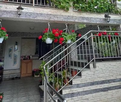 a staircase with potted plants on the side of a building at Apartman Kenan in Bihać