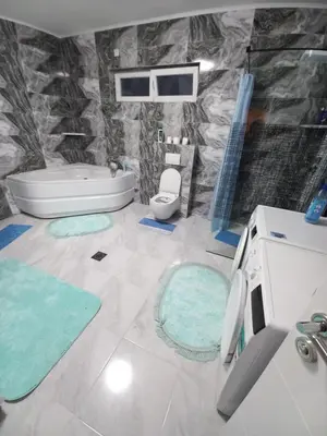 a bathroom with a tub and a toilet and a sink at Apartman Kenan in Bihać