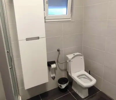 a small bathroom with a toilet and a window at Black Forest House in Banja Luka