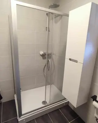 a shower with a glass door in a bathroom at Black Forest House in Banja Luka