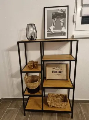 a shelf with a picture and a basket on it at Black Forest House in Banja Luka
