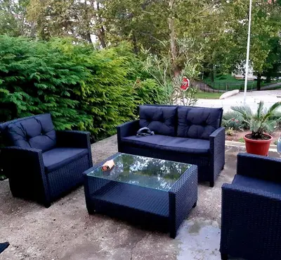 a patio with three chairs and a coffee table at Black Forest House in Banja Luka
