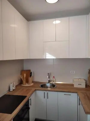 a kitchen with white cabinets and a sink at Black Forest House in Banja Luka