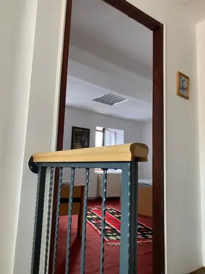 a hallway with a staircase with a mirror at Apartman ''Trg'' in Tuzla