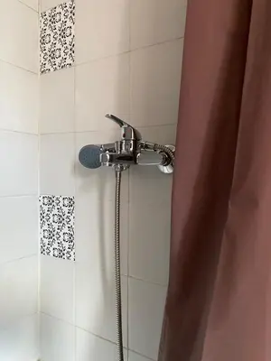 a shower with a faucet in a bathroom at Apartman ''Trg'' in Tuzla