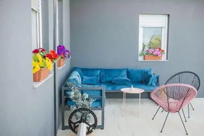 a living room with a blue couch and two chairs at Villa De Luxe Infinity in Bihać