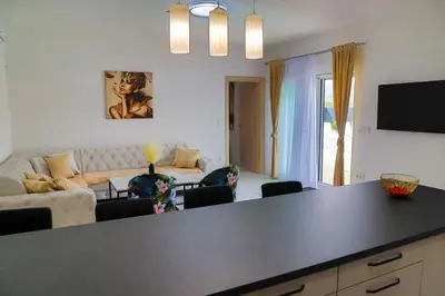 a kitchen and living room with a black counter top at Villa De Luxe Infinity in Bihać