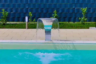 a fountain in the middle of a swimming pool at Villa De Luxe Infinity in Bihać