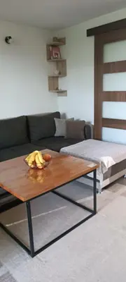 a living room with a coffee table and a couch at Pyramid Holiday House in Visoko