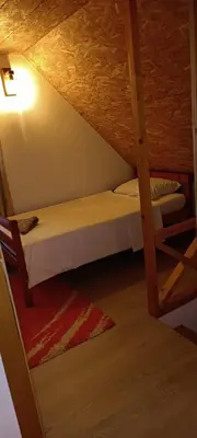 a bedroom with two bunk beds in a room at Pyramid Holiday House in Visoko