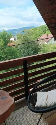 a bench sitting on a balcony with a view at Pyramid Holiday House in Visoko