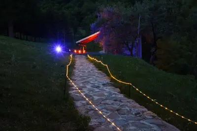 a stone path with lights on it at night at Oaza Mira - Sakina Pecina in Fojnica