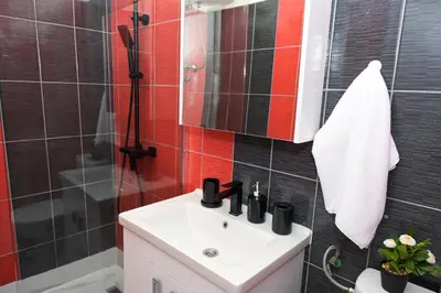 a bathroom with a sink and a shower at Apartman Kiko in Jajce