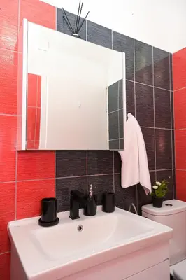 a bathroom with a white sink and a mirror at Apartman Kiko in Jajce