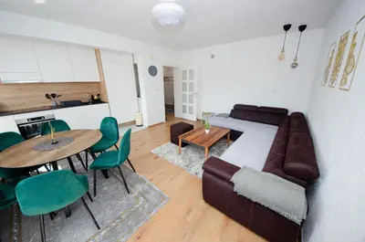 a living room with a couch and a table at Apartment Center Korzo in Bihać