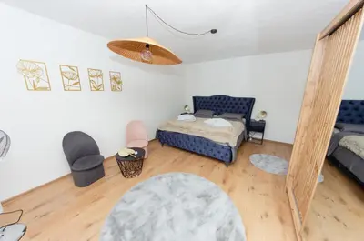 a living room with a bed and a couch at Apartment Center Korzo in Bihać
