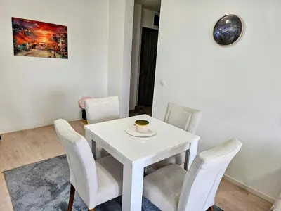 a white table with chairs and a cup of coffee on it at Apartman Aura in Bosanska Gradiška