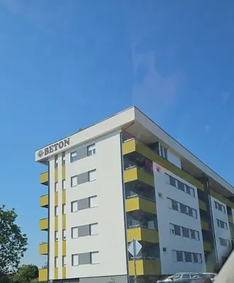 a building with a sign on top of it at Apartman Aura in Bosanska Gradiška