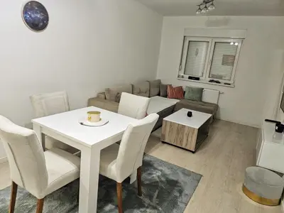 a living room with a white table and a couch at Apartman Aura in Bosanska Gradiška