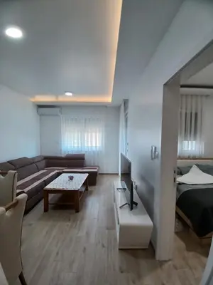 a living room with a couch and a bed at SMART LUX Apartment in Modriča