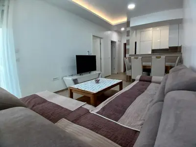 a living room with a couch and a table at SMART LUX Apartment in Modriča