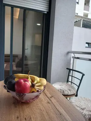 a bowl of fruit sitting on top of a table at SMART LUX Apartment in Modriča