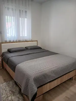 a bedroom with a large bed in a room at SMART LUX Apartment in Modriča