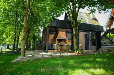 a house with a courtyard with a fireplace at Vikendica Villa Natasa in Banja Luka