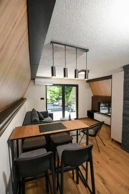 a kitchen and dining room with a table and chairs at Vikendica Villa Natasa in Banja Luka